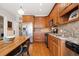 Kitchen featuring wood cabinets, granite counters, stainless appliances, and wood flooring at 1532 Oak Grove Rd, Decatur, GA 30033