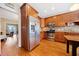 Well-lit kitchen featuring stainless steel appliances, wooden cabinetry and hardwood floors at 1532 Oak Grove Rd, Decatur, GA 30033