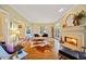 Stylish living room featuring a fireplace, French doors, hardwood floors, and modern furnishings at 1532 Oak Grove Rd, Decatur, GA 30033
