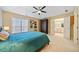 Comfortable main bedroom featuring a ceiling fan, ensuite bathroom, and a large window for ample natural light at 1532 Oak Grove Rd, Decatur, GA 30033