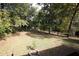 This backyard features mature trees and an expansive, partially shaded lawn at 2491 Hatfield Cir, Atlanta, GA 30316