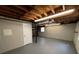 Basement area featuring painted concrete flooring, block walls, and exposed ceiling, offering potential for storage or finishing at 2491 Hatfield Cir, Atlanta, GA 30316