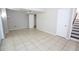 Spacious basement featuring tile floors, access to the staircase, and a door to another room at 2491 Hatfield Cir, Atlanta, GA 30316