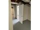 View of the basement leading to a small bathroom with a white pedestal sink and a standard toilet at 2491 Hatfield Cir, Atlanta, GA 30316