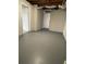 Basement area showcasing a neutral palette, with concrete flooring, exposed duct work and access to other rooms at 2491 Hatfield Cir, Atlanta, GA 30316