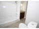 The bathroom features a white tub, shower, wood-look floors, and granite vanity at 2491 Hatfield Cir, Atlanta, GA 30316