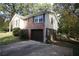 Well-maintained split-level home showing the brick and vinyl siding, with an integrated garage at 2491 Hatfield Cir, Atlanta, GA 30316