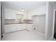 This kitchen includes white cabinets, butcher block countertops, and tile floors at 2491 Hatfield Cir, Atlanta, GA 30316