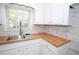 This kitchen features butcher block countertops and a stainless steel sink at 2491 Hatfield Cir, Atlanta, GA 30316