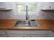 This kitchen showcases a stainless steel sink and butcher block countertops at 2491 Hatfield Cir, Atlanta, GA 30316