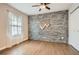Bedroom with accent wall, hardwood floors, ceiling fan, and closet at 2797 Gresham Se Rd, Atlanta, GA 30316