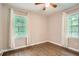 Bedroom featuring hardwood floors, two windows, and white curtains at 2797 Gresham Se Rd, Atlanta, GA 30316