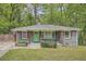 Charming grey brick home with a bright green front door and wood column accents at 2797 Gresham Se Rd, Atlanta, GA 30316
