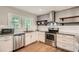 Modern kitchen with stainless steel appliances, white cabinets, and granite countertops at 2797 Gresham Se Rd, Atlanta, GA 30316