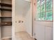 Laundry room with shelving, tile flooring, and a windowed door at 2797 Gresham Se Rd, Atlanta, GA 30316