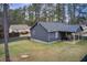 Large backyard with mature trees and a covered porch perfect for outdoor living at 335 Old Airport Rd, Carrollton, GA 30116