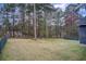 Expansive backyard, bordered by mature trees, provides privacy and space for recreation at 335 Old Airport Rd, Carrollton, GA 30116