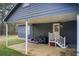 Backyard view with patio area, exterior door, and blue siding at 335 Old Airport Rd, Carrollton, GA 30116