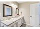 Bright bathroom with double sink vanity, decorative mirrors and wood-look flooring at 335 Old Airport Rd, Carrollton, GA 30116
