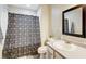 Bathroom with dark shower curtain, white vanity, mirror and toilet at 335 Old Airport Rd, Carrollton, GA 30116
