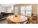Open-concept dining area flowing into living room, bright with natural light from large windows at 335 Old Airport Rd, Carrollton, GA 30116