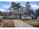 Inviting home with a covered carport, charming porch, and well-maintained lawn at 335 Old Airport Rd, Carrollton, GA 30116