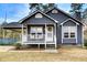 Charming single-Gathering home with welcoming front porch, white trim, and a covered carport at 335 Old Airport Rd, Carrollton, GA 30116