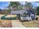 Attractive home boasting a welcoming porch, convenient carport, and manicured landscaping at 335 Old Airport Rd, Carrollton, GA 30116