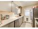 Galley kitchen with stainless steel appliances and grey wood-look flooring at 335 Old Airport Rd, Carrollton, GA 30116