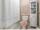 Cozy bathroom with a shower-tub combination and white linen cabinet at 1132 Venetian Ln, Hampton, GA 30228