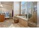 Relaxing bathroom with a soaking tub, separate glass shower, and neutral tile work at 1132 Venetian Ln, Hampton, GA 30228