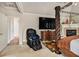Spacious bedroom featuring a canopy bed, fireplace, and a comfortable massage chair at 1132 Venetian Ln, Hampton, GA 30228