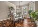 Charming dining area featuring a glass table, decorative chairs, and natural light from large windows at 1132 Venetian Ln, Hampton, GA 30228