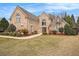 Charming brick home featuring manicured landscaping, arched windows, and a welcoming front entrance at 1132 Venetian Ln, Hampton, GA 30228