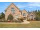 Beautiful brick home with meticulously maintained landscaping, featuring arched windows and a double-door entry at 1132 Venetian Ln, Hampton, GA 30228