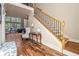Inviting foyer with hardwood floors, a staircase, and views of a sunlit living area at 1132 Venetian Ln, Hampton, GA 30228