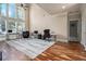 Bright and open living area featuring hardwood floors, large windows, and versatile workspace at 1132 Venetian Ln, Hampton, GA 30228