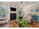 Cozy living room with a fireplace, hardwood floors, and large windows providing ample natural light at 1132 Venetian Ln, Hampton, GA 30228