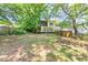 Home's backyard is expansive and filled with lush, mature trees and greenery at 1247 Monroe Ne Dr, Atlanta, GA 30306