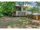 View of the home's backyard featuring a wooden deck, screened porch, and lush foliage at 1247 Monroe Ne Dr, Atlanta, GA 30306