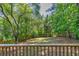 Secluded backyard with mature trees and a wood fence as seen from the deck at 1247 Monroe Ne Dr, Atlanta, GA 30306