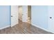 Spacious finished basement featuring light blue walls and multiple white doors at 1247 Monroe Ne Dr, Atlanta, GA 30306
