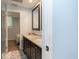 Bathroom featuring double sinks, granite countertops, and a glass-enclosed shower at 1247 Monroe Ne Dr, Atlanta, GA 30306