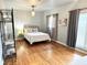 This bedroom features hardwood floors, one bed with large windows and a clothing rack at 1247 Monroe Ne Dr, Atlanta, GA 30306