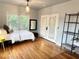This bright bedroom features hardwood floors, a closet, access to a balcony and large windows at 1247 Monroe Ne Dr, Atlanta, GA 30306