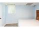 A calming bedroom with wood-look flooring, a tiled ceiling, and serene light-blue walls at 1247 Monroe Ne Dr, Atlanta, GA 30306