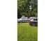 Exterior view showing green yard with three cars parked in driveway at 1247 Monroe Ne Dr, Atlanta, GA 30306