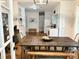 Charming kitchen featuring white cabinetry, modern appliances, and a rustic wooden dining table at 1247 Monroe Ne Dr, Atlanta, GA 30306