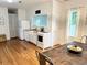 Bright kitchen featuring white cabinetry, modern appliances, and a rustic dining table at 1247 Monroe Ne Dr, Atlanta, GA 30306