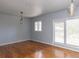 This empty living room features hardwood floors and plenty of light from the large windows at 1247 Monroe Ne Dr, Atlanta, GA 30306